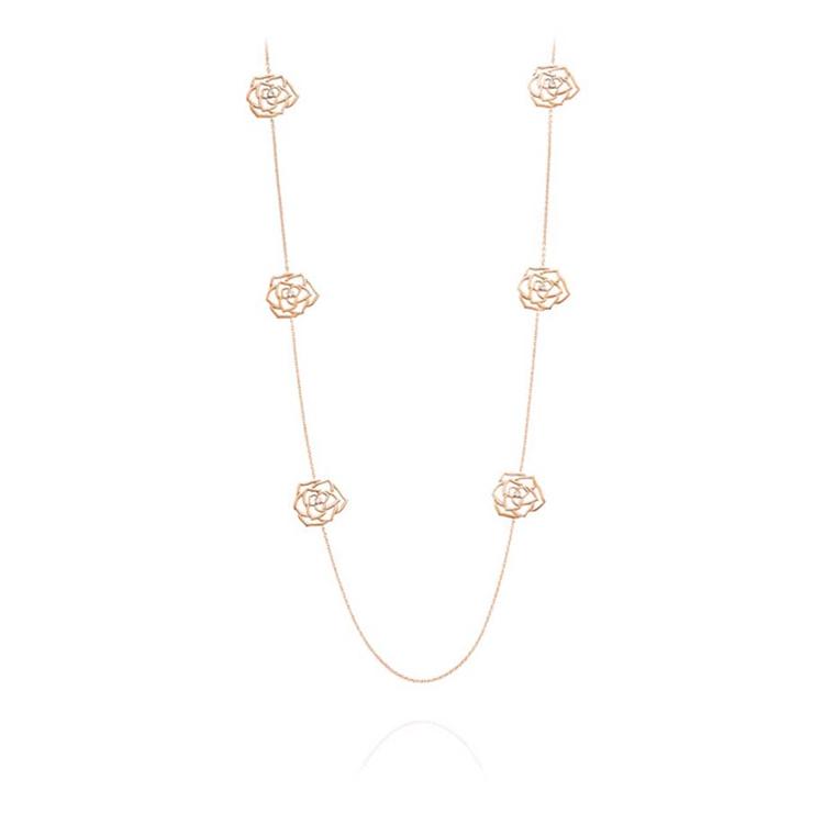 Piaget Rose necklace featuring the silhouettes of six Piaget roses in rose gold, each with a single diamond at its heart.